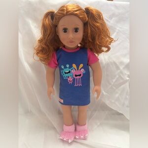 Our Generation 18-inch doll, wearing the "Snuggle Monster" pajama outfit